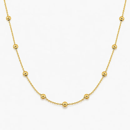 Lucche 14K gold beaded necklace with polished gold spheres on a delicate chain