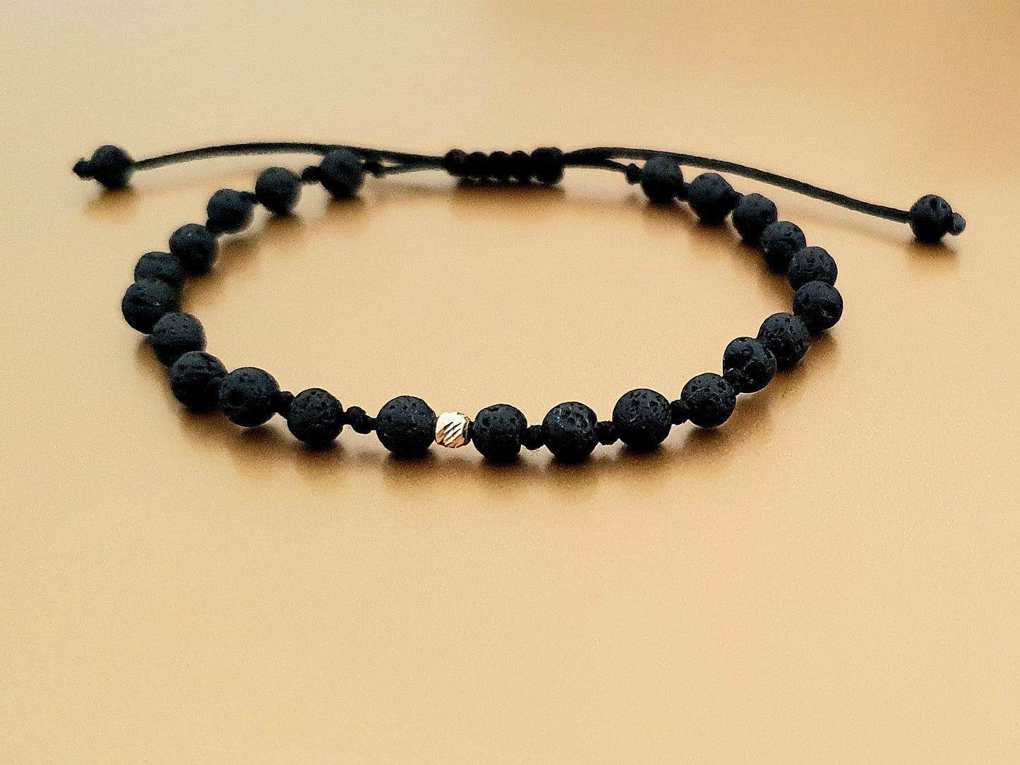Bracelets made of gold beads and natural lava stones