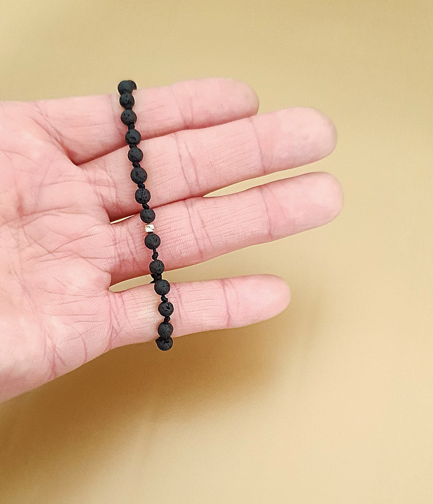 Bracelets made of gold beads and natural lava stones