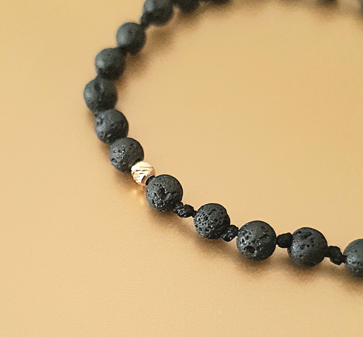 Bracelets made of gold beads and natural lava stones