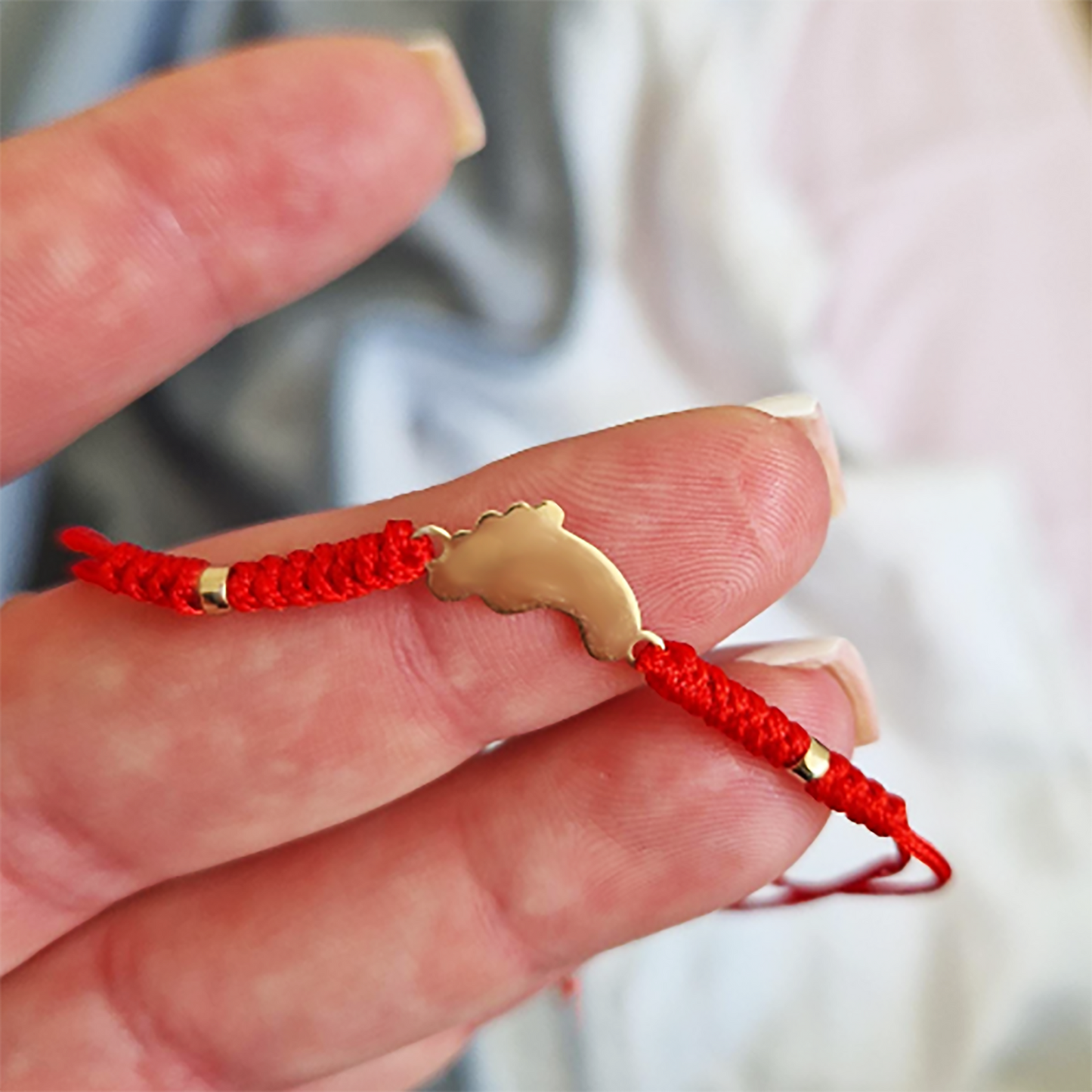 Red thread bracelet with gold bead